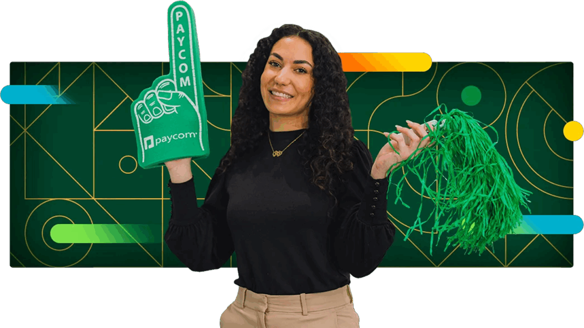 Woman with curly hair wears a Paycom branded foam finger.