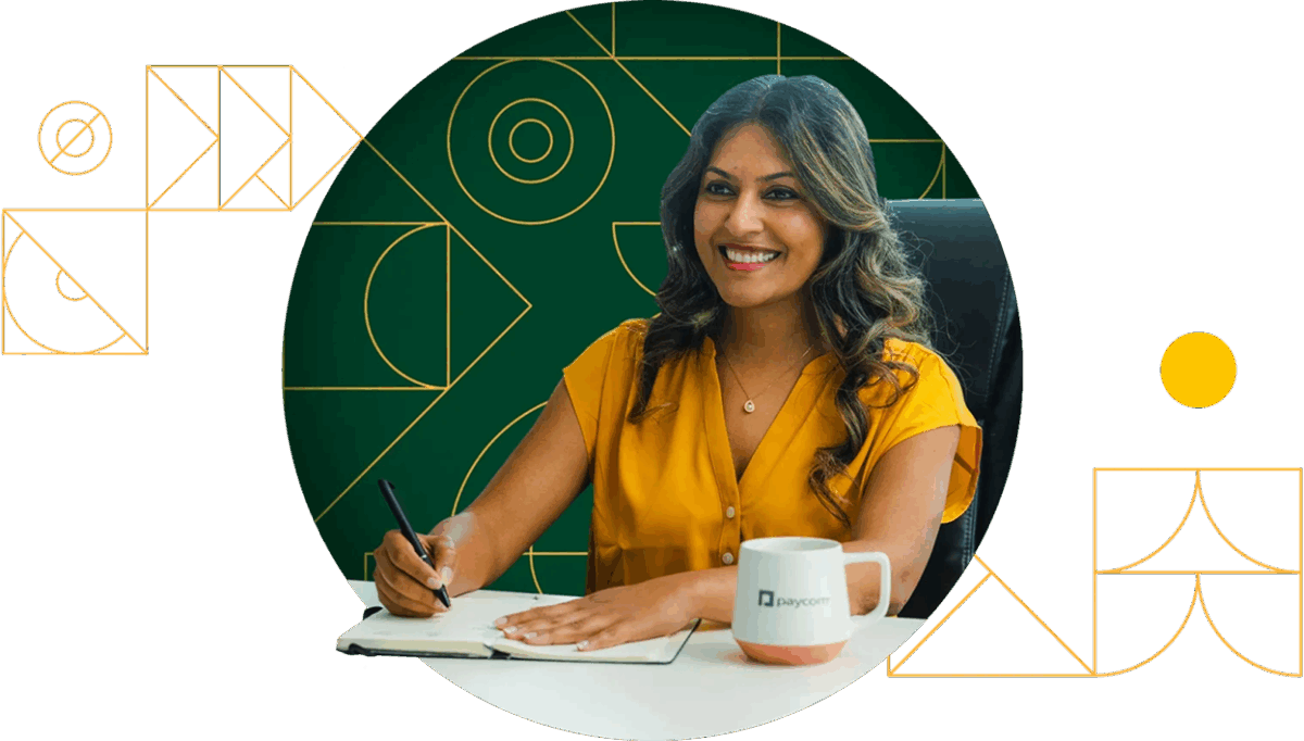A smiling Paycom associate wearing an orange shirt smiles at colleague while participating in meeting.